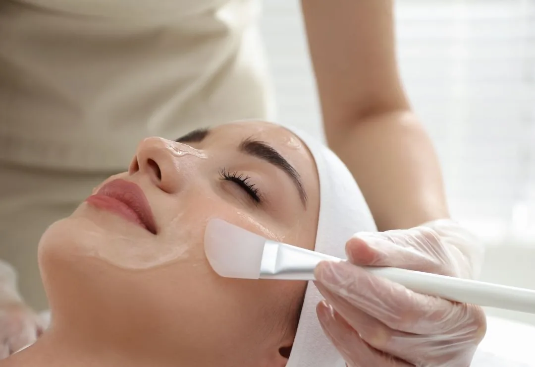 A treatment mask brushed onto a client's face